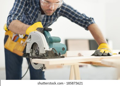 Carpenter working with circular saw