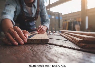 Carpenter working with equipment on wooden table in carpentry shop. woman works in a carpentry shop. - Shutterstock ID 1296777337