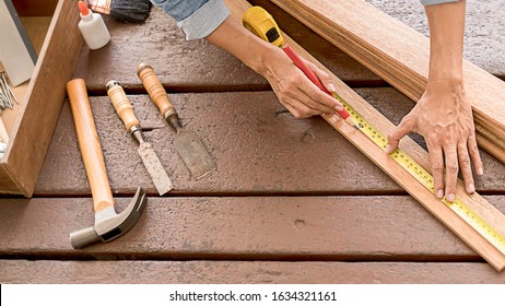 Carpenter working with equipment on wooden table in carpentry shop. woman works in a carpentry shop. - Shutterstock ID 1634321161
