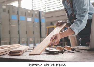 Carpenter working with equipment on wooden table in carpentry shop. woman works in a carpentry shop.