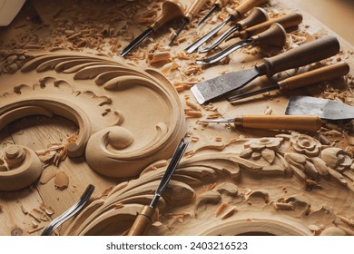 Carpenter working with his tools in his workshop. Cutting a piece of wood.