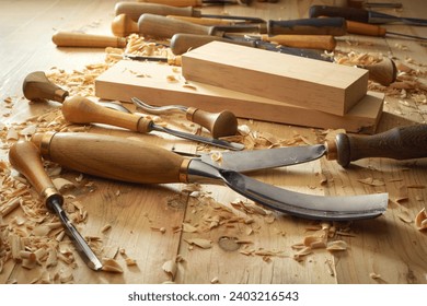 Carpenter working with his tools in his workshop. Cutting a piece of wood.