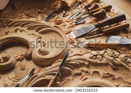 Carpenter working with his tools in his workshop. Cutting a piece of wood.