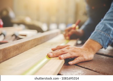 Carpenter working on woodworking machines in carpentry shop. woman works in a carpentry shop. - Shutterstock ID 1081695314