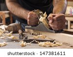 carpenter working  with  plane  on wooden background