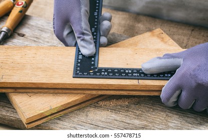 Carpenter Working With A Square Metal Angle