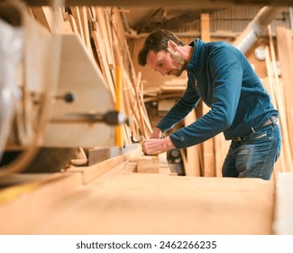 Carpenter Working In Woodwork Workshop Measuring Wood For Project - Powered by Shutterstock