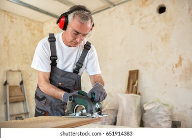 Carpenter is working in a workshop, close up - Powered by Shutterstock