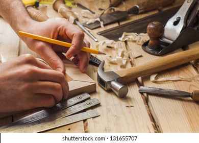 carpenter working,hammer,meter and screw-driver on construction background