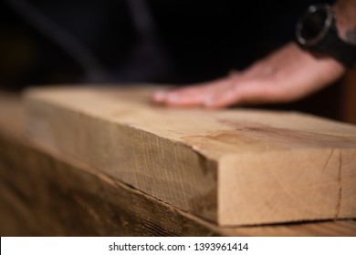 Carpenter Works With Old Reclaimed Oak Wood Beam To Build A Double Bed