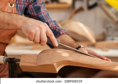 Carpenter Works With A Planer In A Workshop For The Production Of Vintage Furniture. He Makes Cabriole Leg For A Table In The Style Of Louis XV And Queen Anne/Joiner Makes Cabriole Leg For Vintage Tab