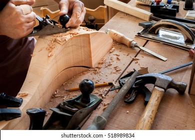 Carpenter Works With A Planer In A Workshop For The Production Of Vintage Furniture. He Makes Cabriole Leg For A Table In The Style Of Louis And Queen Anne/Joiner Makes Cabriole Leg For Vintage Table