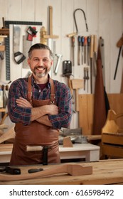 Carpenter Works With A Planer In A Workshop For The Production Of Vintage Furniture. He Makes Cabriole Leg For A Table In The Style Of Louis XV And Queen Anne/Working With Wood Gives Joy