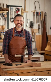 Carpenter Works With A Planer In A Workshop For The Production Of Vintage Furniture. He Makes Cabriole Leg For A Table In The Style Of Louis XV And Queen Anne/Working With Wood Gives Joy