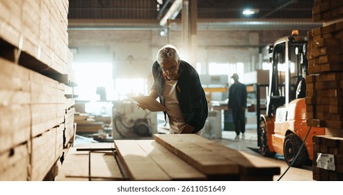 Carpenter, workshop and clipboard with wood inspection for quality control, inventory management and timber evaluation. Manufacturing, mature man and paperwork for carpentry stock and supply chain - Powered by Shutterstock - Get 15% off with code: PIKWIZARD15