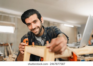 carpenter workshop with timber equipment and carpenter's shop tool, craft woodwork industry by professional craftsman person working in wooden occupation job to make a furniture from wood plank - Powered by Shutterstock