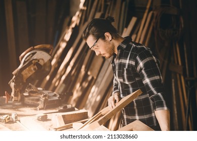 The carpenters man high experienced wood worker making furniture. master of woodcraft male looking at workpiece closeup with fine detail. - Shutterstock ID 2113028660