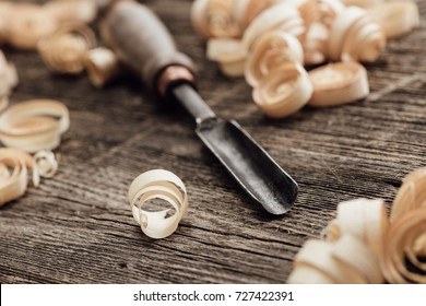 Carpenter's old workbench: gouge and wood shavings close up, woodworking and DIY concept