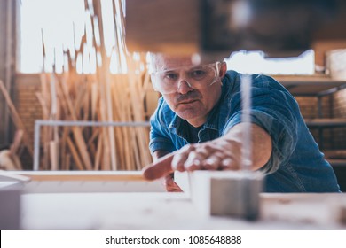 Carpenters using circular saw in workshop