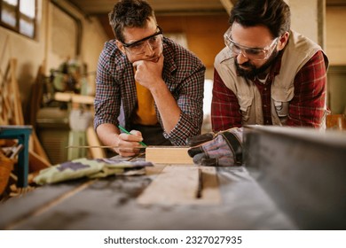 Carpenters working in their woodworking workshop - Powered by Shutterstock