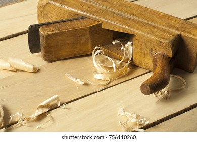 Carpentry concept. Joiner carpenter workplace. Old planer on wooden table with sawdust. - Shutterstock ID 756110260