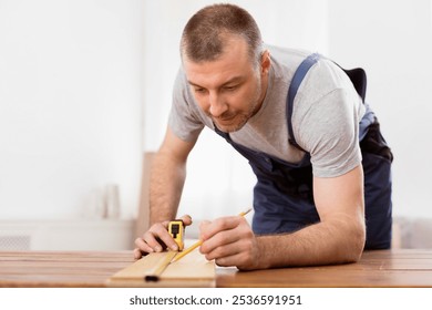 Carpentry Concept. Professional Carpenter Measuring Wooden Board Working On A Piece Of Furniture Indoors. Selective Focus - Powered by Shutterstock