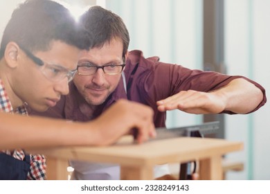 Carpentry teacher and student examining measurement - Powered by Shutterstock