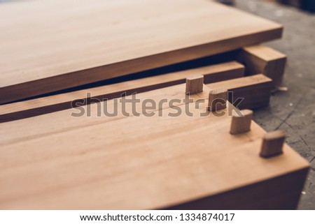 Carpentry workshop - professional woodworking - legs for a wooden table with tenon joints - cotter pins