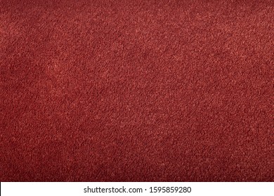 Carpet covering background. Pattern and texture of burgundy colour carpet. Copy space