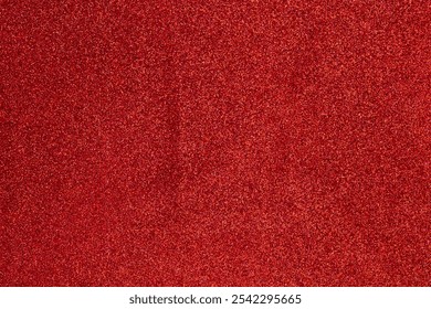 A carpet with a lot of red glitter on it. The carpet is very shiny and the glitter is very sparkly - Powered by Shutterstock