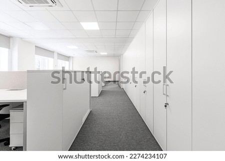 Carpeted corridor between lockers. Shrinking perspective. Selective focus.
