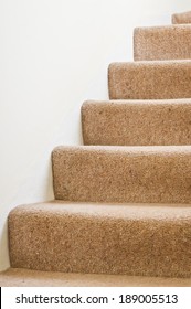 Carpeted Stairs In A House Against A White Wall