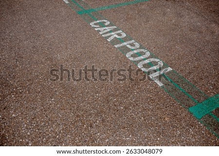 Carpool parking symbol painted on asphalt parking lot surface informing that this parking spot is reserved for car sharing drivers. Parking space for carpooling drivers
