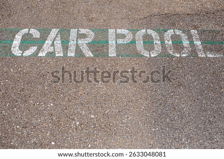 Carpool parking symbol painted on asphalt parking lot surface informing that this parking spot is reserved for car sharing drivers. Parking space for carpooling drivers