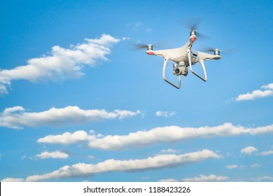 CARR, CO, USA - APRIL 12, 2017:  DJI Phantom 4 pro quadcopter drone flying with a camera against blue sky with some clouds.