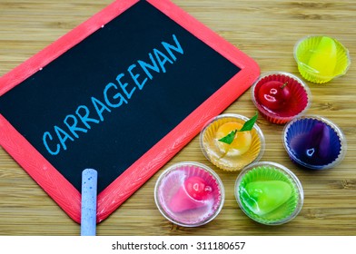 Carrageenan written on chalkboard with jelly desserts on wood background