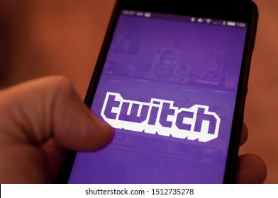 Carrara, Italy - September 24, 2019: Man run Twitch application on a smartphone. Twitch is a live streaming platform owned by Amazon