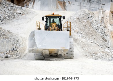 Carrara, Tuscany, Italy - August 17, 2020 : Machinery moving a block of white Carrara marble in a quarry in Tuscany, Italy