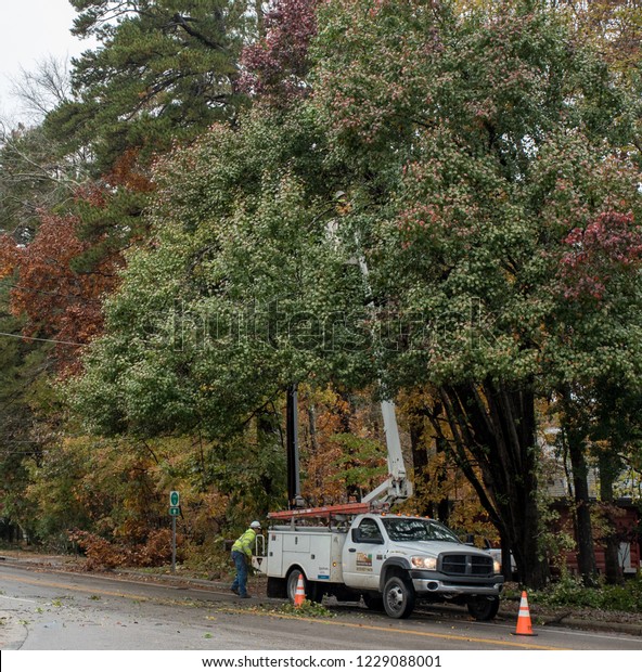 Carrboro, North\
Carolina, US-November 13, 2018: Workers repairing power lines after\
tree fell on them in\
storm