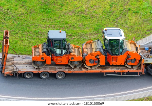 Carriage\
on a trailer platform of asphalt paver\
roller.