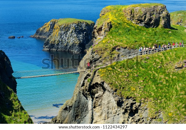 Carrick-a-Rede Rope Bridge, famous rope bridge\
near Ballintoy in County Antrim, linking the mainland to the tiny\
island of Carrickarede. One of the most iconic tourist attractions\
in Nothern\
Ireland.