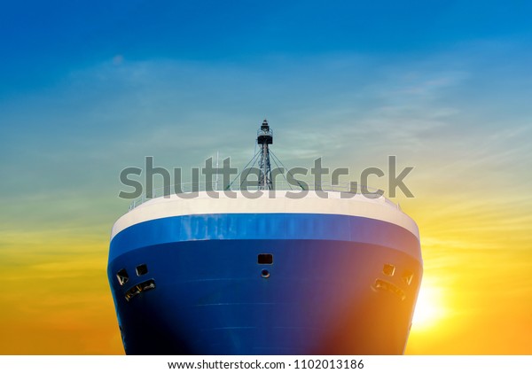 Carrier Vessel forward Automobile\
Transporter of Cargo ship on sunshine light\
background