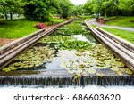 Carroll Creek in Frederick, Maryland city park with canal and fountain waterfall and flowers in summer