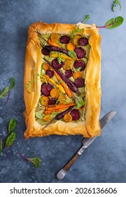 Carrot and Beet Tart with pesto and phyllo dough. Savoury vegetable baking. Homemade vegetarian food.Top view.