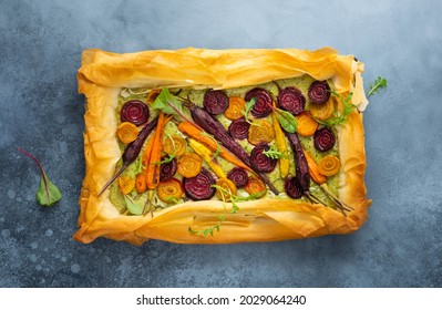 Carrot and Beet Tart with pesto and phyllo dough. Savoury vegetable baking. Homemade vegetarian food.Top view.