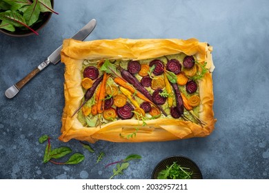 Carrot and Beet Tart with pesto and phyllo dough. Savoury vegetable baking. Homemade vegetarian food.Top view. - Shutterstock ID 2032957211