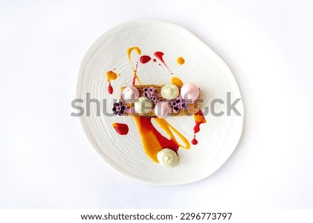 Carrot cake with berry mousse on a white plate isolated