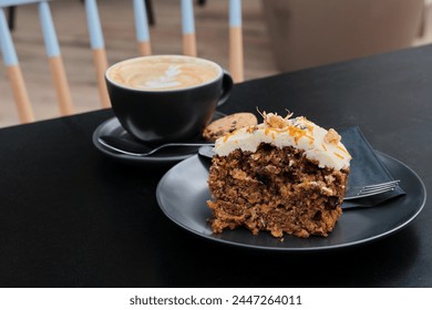 Carrot cake dessert accompanied by a cup of coffee on the table. Favorite delicious coffee cake. Cup of espresso coffee - Powered by Shutterstock