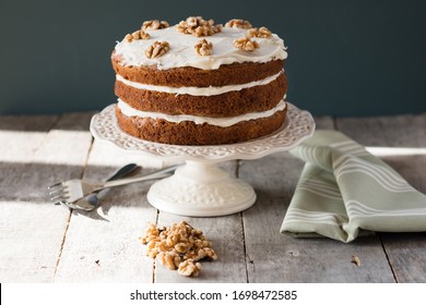 Carrot Cake With Icing Served On A Cake Stand