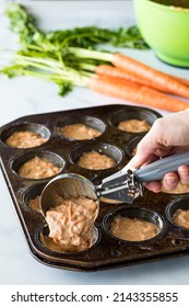 Carrot Cake Muffin Batter Being Scooped Into A Muffin Tin For Baking.